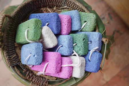 Colorful Pumice Stones with Strings Displayed in a Basket for Skincareの写真素材