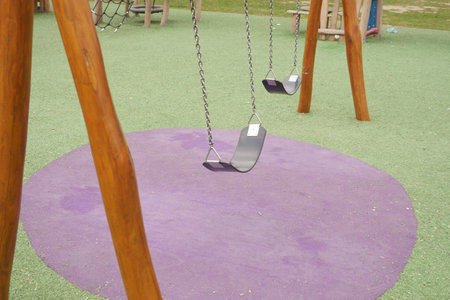 Close-up of a baby swing in the playgroundの写真素材