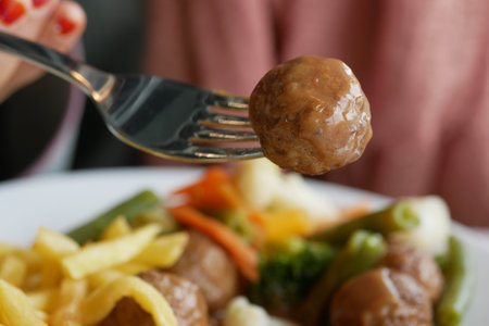 Delicious Meatballs Served with Colorful Vegetablesの写真素材