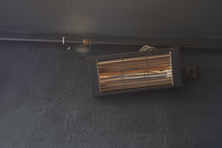 Wall-mounted space heater provides warmth in a cozy indoor setting during the winter monthsの写真素材