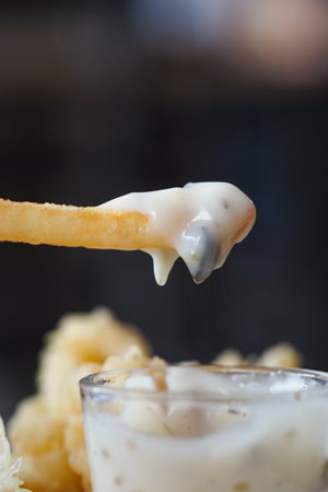 Crispy french fry with creamy dip in a restaurant settingの写真素材