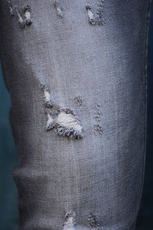 Torn denim jeans showing distressed fabric detailの写真素材