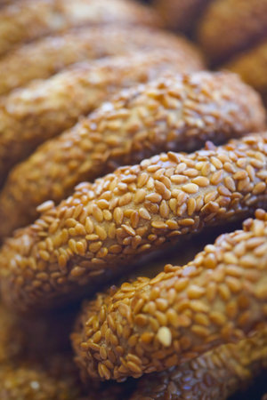 Delicious sesame-coated treats stacked on display at a market