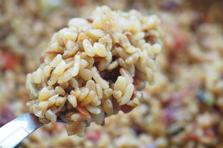 Warm brown rice salad with fresh vegetables and herbsの写真素材