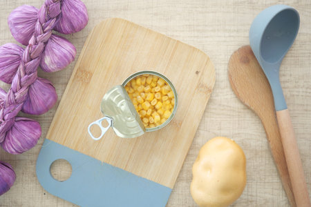 Corn and potato preparation on a wooden cutting boardの写真素材