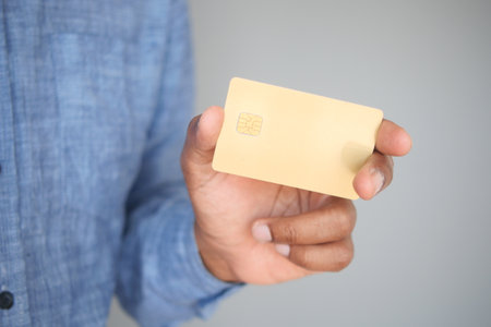 Holding a blank card in a casual setting with neutral backgroundの写真素材