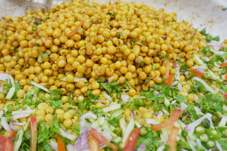 Dish of spiced yellow peas served with fresh chopped vegetablesの写真素材