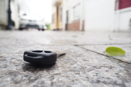 Car key lying on the ground in a residential areaの写真素材