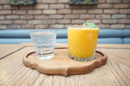 Refreshing drinks served on a wooden tray in a cozy settingの写真素材