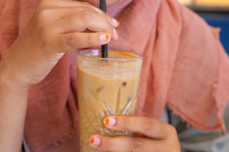 Enjoying a refreshing iced coffee drink in a cozy cafe