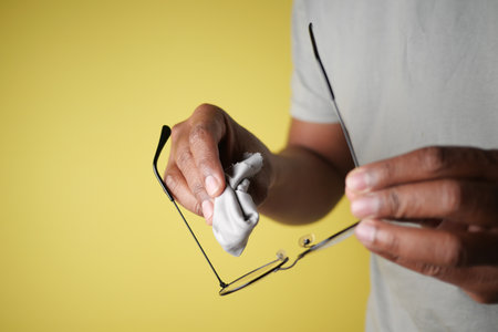 Cleaning glasses with a microfiber cloth for clearer visionの写真素材