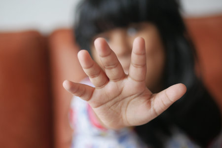 A Child Joyfully Reaching Out with a Playful and Cheerful Gesture, Radiating Innocence and Happinessの写真素材