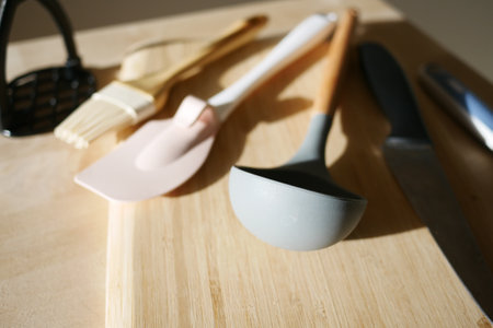 A Variety of Cooking Utensils Displayed on a Wooden Surface Tableの写真素材