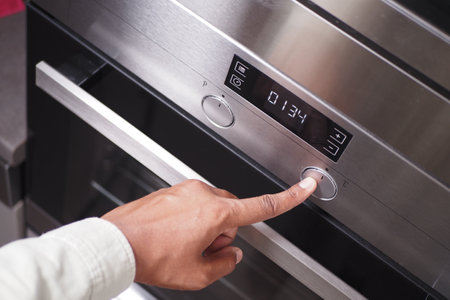 A modern kitchen oven with a digital display and touch controls for easy usabilityの写真素材