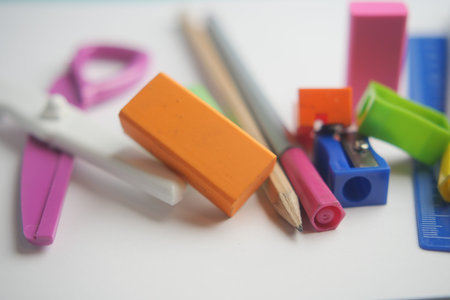 Colorful stationery supplies scattered on a clean desk surface