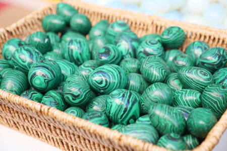 Colorful green decorative stones arranged in a woven basket