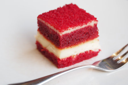 Delightful red velvet cake slice served with a fork