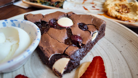 Delicious chocolate dessert served with fresh strawberries and creamの写真素材