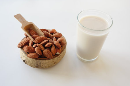 Almonds and almond milk displayed in a rustic settingの写真素材