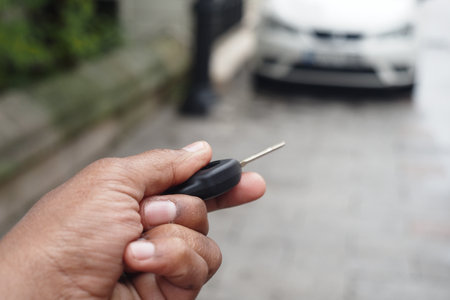 Unlocking a car using a remote key in an urban areaの写真素材