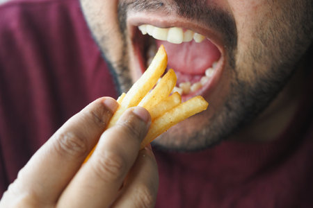 Enjoying crispy fries in a casual dining momentの写真素材