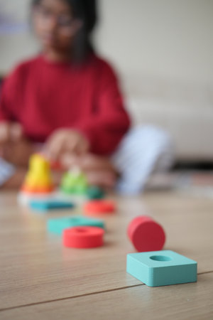 Child engages in creative play with colorful building blocksの写真素材