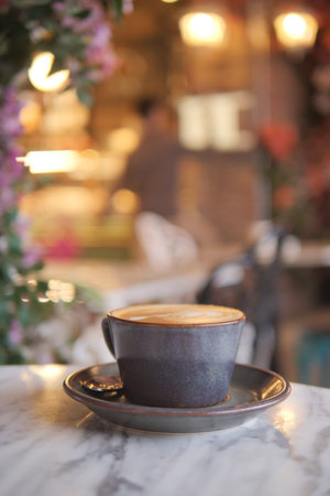 Coffee cup on a marble table in a cozy cafe atmosphere