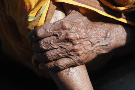 Elderly hands intertwined, expressing care and connectionの写真素材