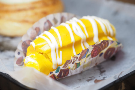 Delicious dessert with sweet cream and vibrant yellow filling