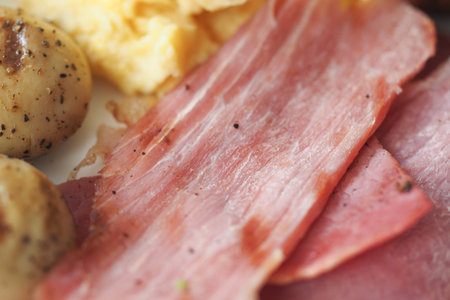 Breakfast platter featuring scrambled eggs and sliced meats