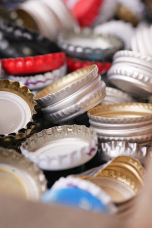 Collection of colorful bottle caps resting in a boxの写真素材