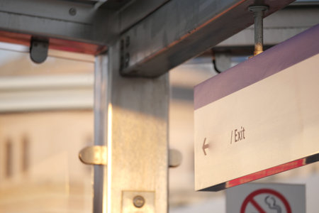 Exit sign in urban transit station during late afternoon light
