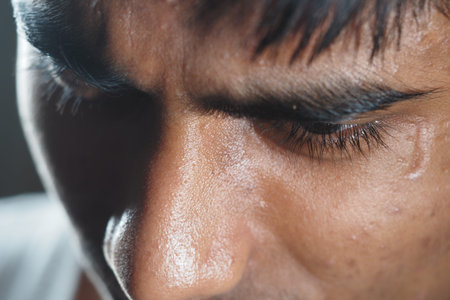 Close-up of a person deep in thought during a quiet momentの写真素材