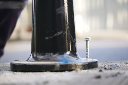 Fixing a pole base on a city street during daylight hours