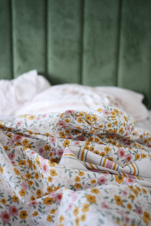 Cozy bed with floral bedding arranged in a relaxed setting