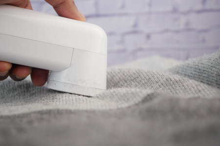 How to effectively remove lint from clothing using a lint removerの写真素材