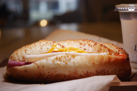 Freshly baked sandwich with cheese and ham on wooden tableの写真素材