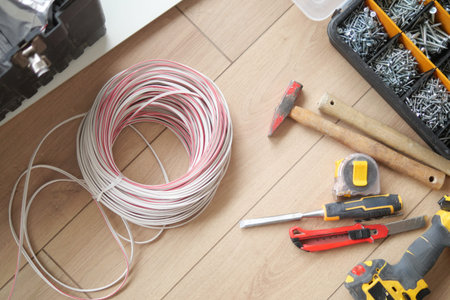 Tools and materials for home improvement project on wooden floor