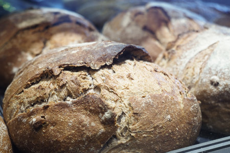 Freshly baked artisan bread displayed in a bakeryの写真素材