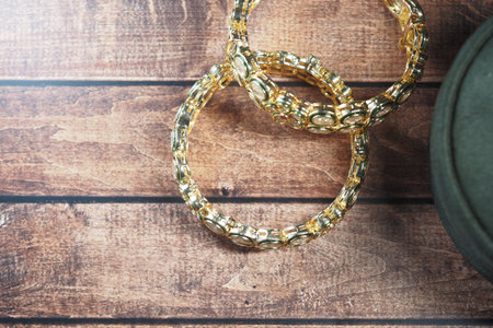 Beautiful gold bangles on a wooden table showcase elegance and style