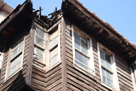 Old wooden structure showing signs of decay in bright sunlight
