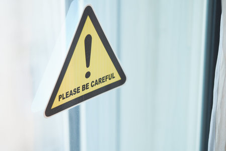 Caution sign urging attention in indoor settingの写真素材
