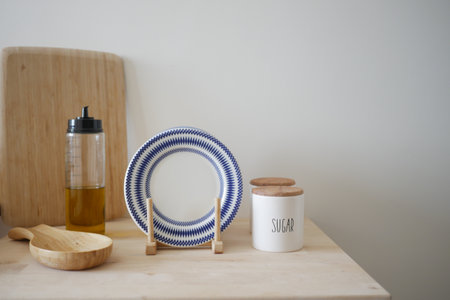 Decorative kitchen setup with blue patterned plate and wooden utensilsの写真素材