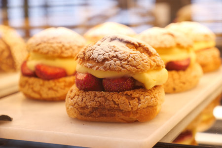 Strawberry-topped cream pastries at the bakeryの写真素材