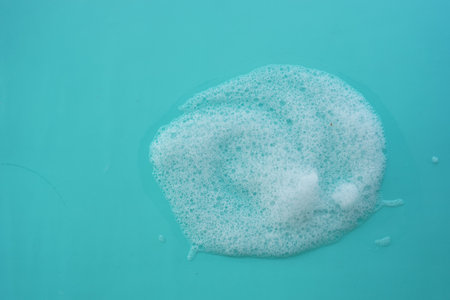 Bubbles forming on a turquoise surface in a clean environmentの写真素材