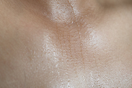 Close-up of glistening skin showing sweat and natural textureの写真素材
