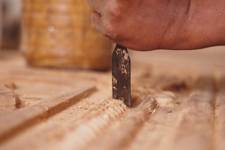 Crafting detailed woodwork with precision in a workshop environmentの写真素材