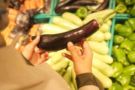 Exploring fresh vegetables at the market on a sunny afternoonの写真素材