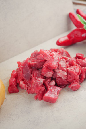 Freshly chopped beef prepared for cooking in a rustic kitchenの写真素材
