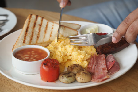 Delicious breakfast served with scrambled eggs and toastの写真素材
